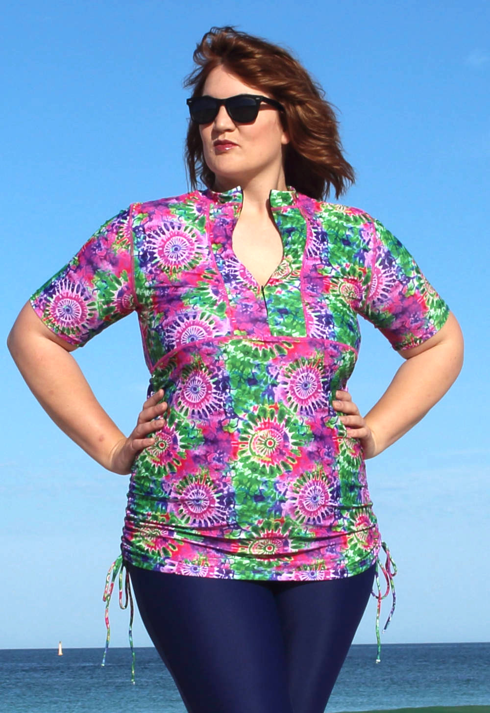 http://oceanroadswimwear.com.au/wp-content/uploads/2019/10/womens-plus-size-short-sleeve-adjustable-swim-shirts-colourful-pink-green-patterned.jpg