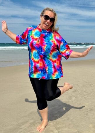 Front View of womens plus size short sleeve chlorine resistant baggy print colourful rashies. featuring tie waist and zip neck