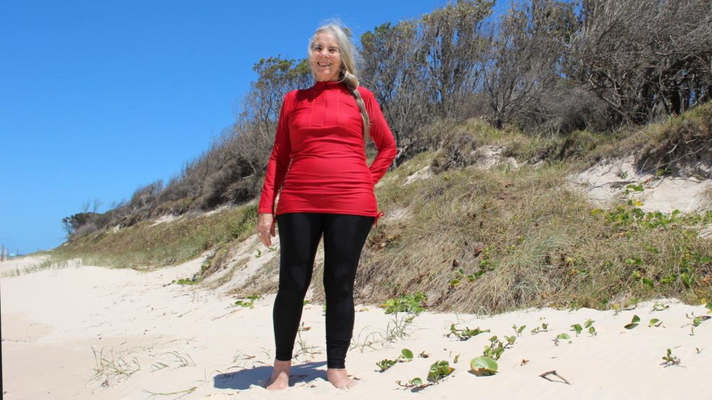 Woman Standing on beach in UPF Sun Safe Swimwear