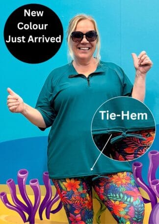 Women's plus size loose fit short sleeve rash guard in Teal featuring a side tie-hem for adjustable fit.