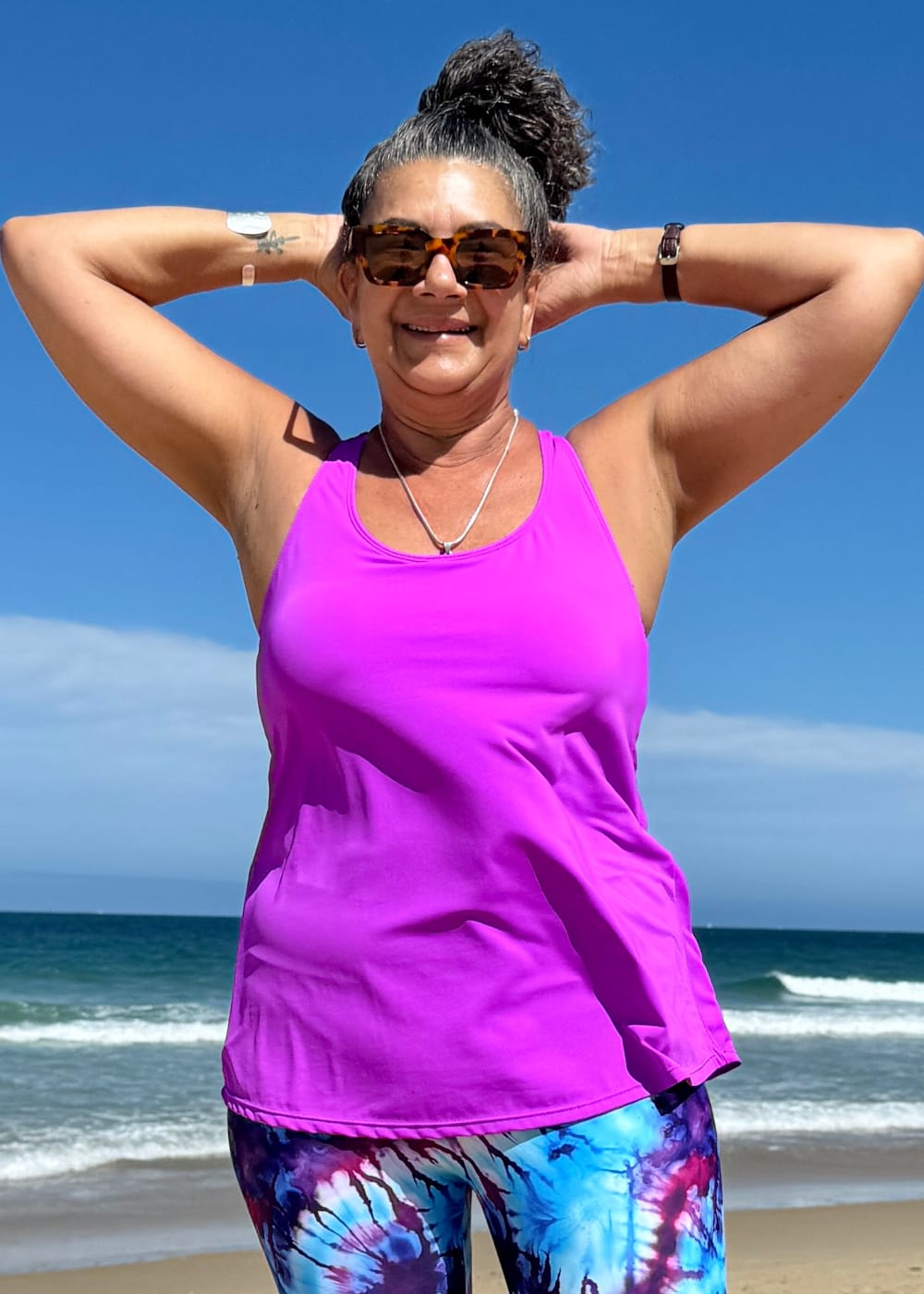 Loose fitting active tankini showing the relaxed non cling waist drape violet pink - tani