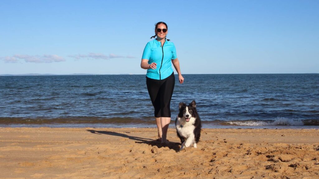 womens swimwear sun safe uv protection swim shirts swim leggings woman and dog on beach running wearing swimwear