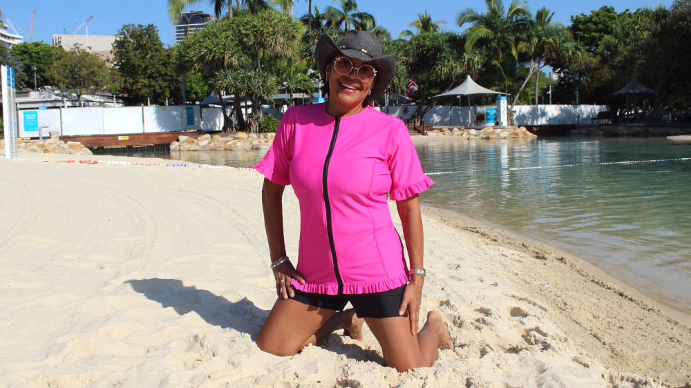 womens wearing pink swim shirt top on beach pretty frills and zip up