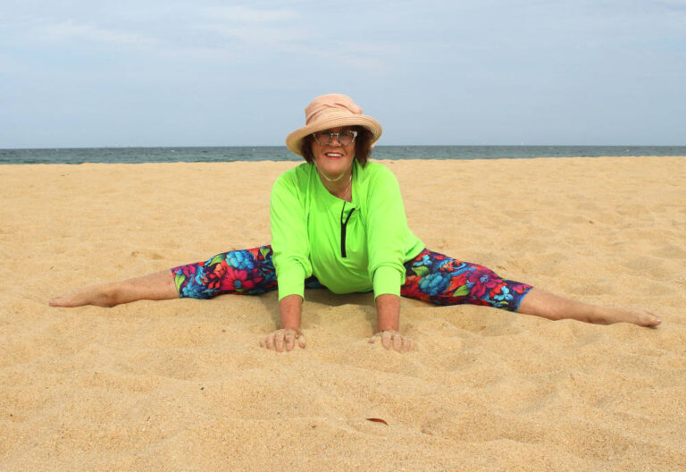 mature women wearing sun protective swimwear doing the splits over 50