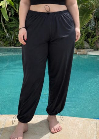 Front view of plus size women's baggy full-length swim pants with a loose fit and UPF 50+ sun protection.