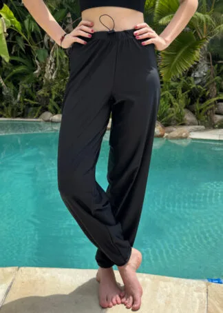 Front view of women's baggy full-length swim pants in a loose fit with UPF 50+ sun protection.